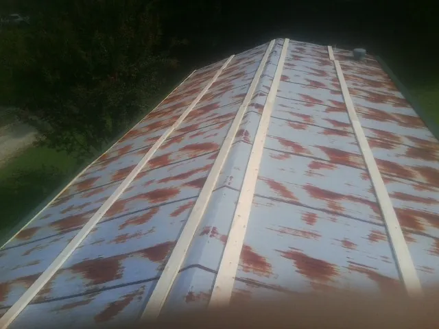 Rusted metal roof panels with new wood purlins before replacement — Storm Damage Roof Repair in Weehawken by Roofing Brothers